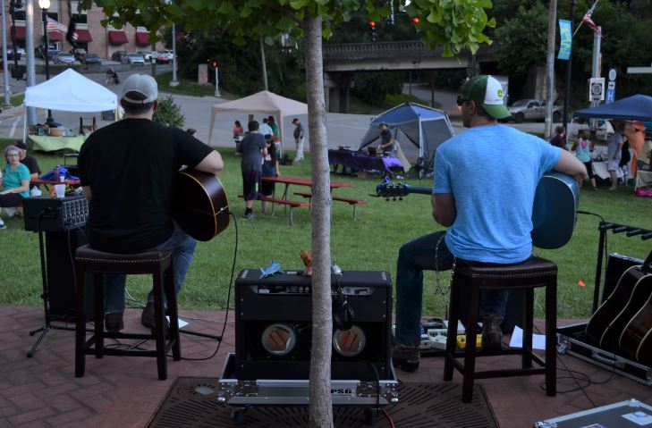 Two people play guitar at a festival in Hazard, Kentucky, a town in the Appalachian mountains going through revitalization.