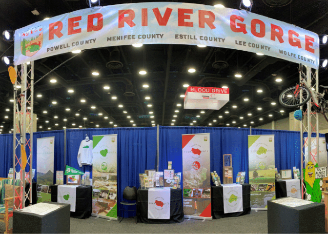 A banner stretches over several booths at the kentucky state fair. SEveral counties partnered to market the red river gorge in eastern ky.