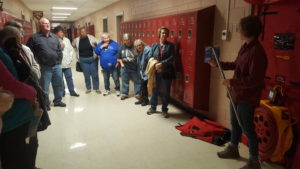 A group stands inside a high school during an energy efficiency training in lancaster, kentucky.