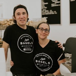 Katie and Michael of Native Bagel Company stand next to each other inside their bagel shop in eastern kentucky