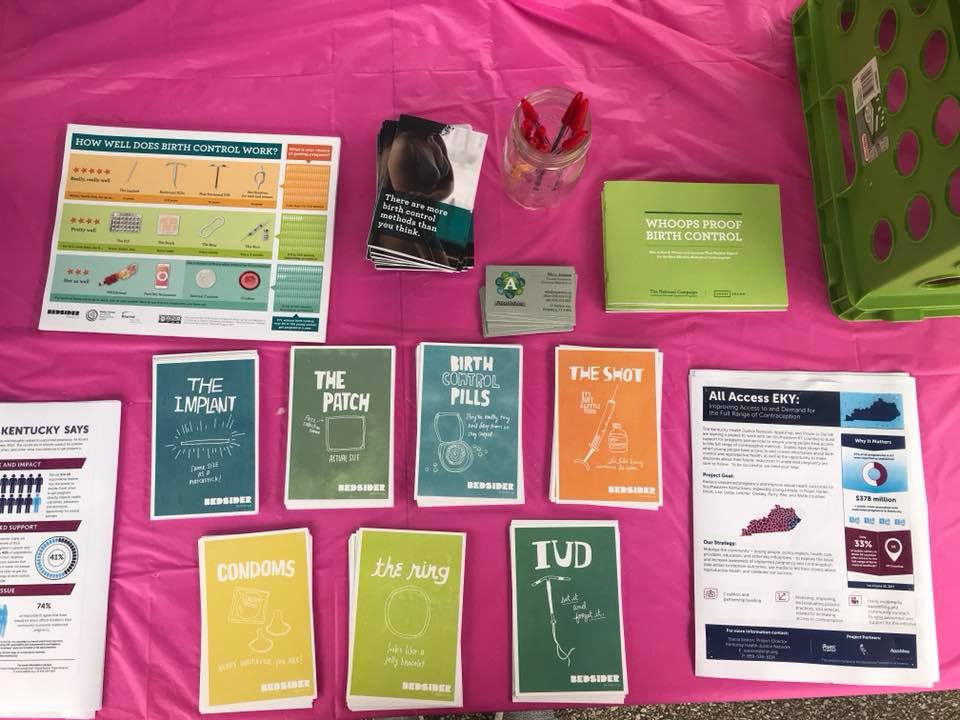 All Access EKY's educational material sit on a pink table at an event in eastern kentucky. The nonprofit supports appalachian youth