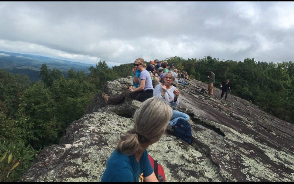 A group of hikers sits on Pine Mountain ridgeline in harlan county, kentucky, at knobby rock. KNLT is supported by MACED