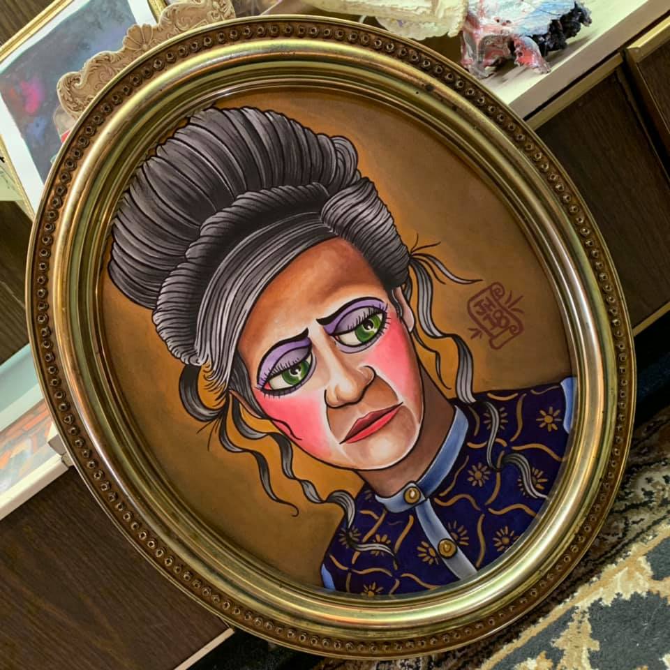 A painting of an old woman, done by john haywood, who also does tattoos and plays mountain music like banjo around eastern kentucky.