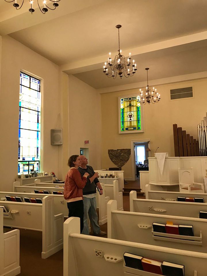 Two MACED employees stand inside First Christian Church in Morehead, Kentucky during an energy efficiency and solar audit.