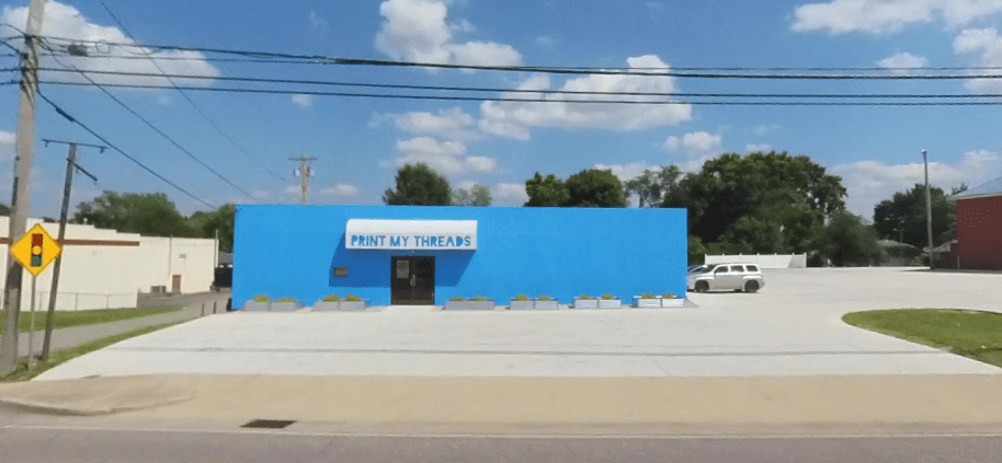The building at print My Threads in flatwoods, kentucky, is painted bright blue. They are a net zero screen printing business