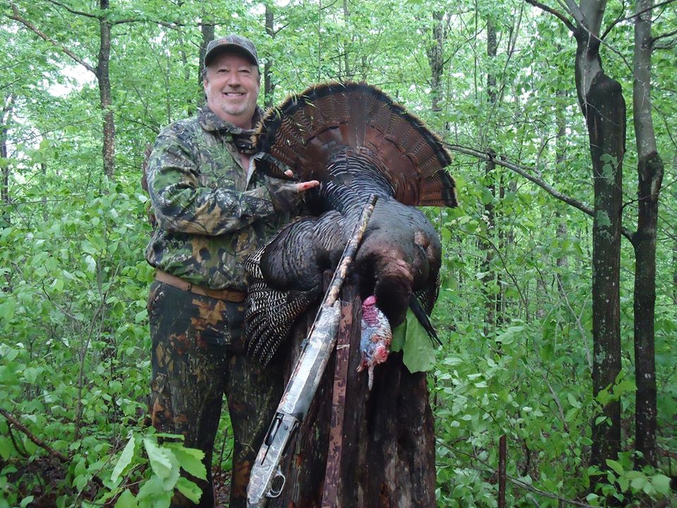 Doug Adkins at Cane Creek Calls in Letcher County in Eastern Kentucky shows off his turkey. he is famous is making hunting calls. 