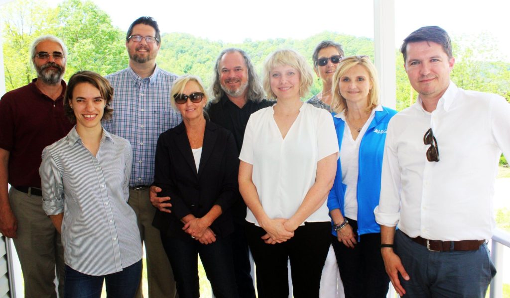 A group of people stand outside. The Appalachian impact fund awards checks to various nonprofits in eastern kentucky