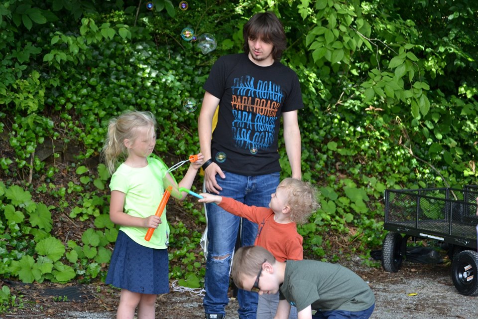 A student works with three young kids at Cowan community center in letcher county, kentucky. The center runs east ky youth programming