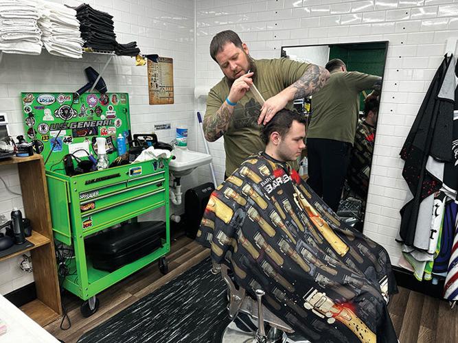 Jade teague cuts hair in his new barber shop