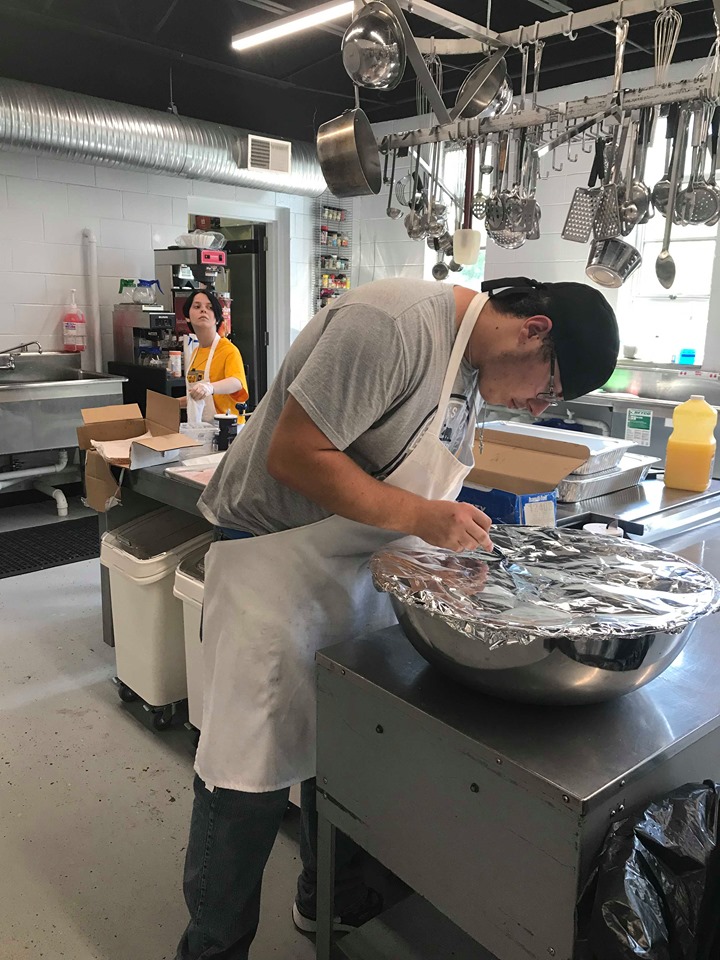 A Eastern Kentuckian works at CANE Kitchen in Letcher County, part of building strong local food systems in Appalachian. 