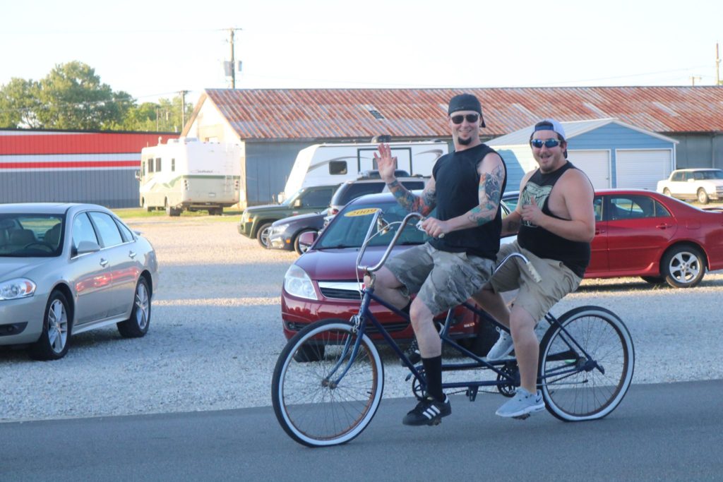 Two men ride a tandem bike in the eastern kentucky community of grayson. Free bikes help counter transportation issues in rural areas