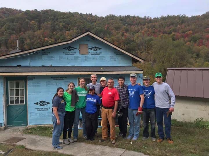 Volunteers stand in front of a house they are building with COAP, Inc., a housing non-profit in Southeastern Kentucky. 