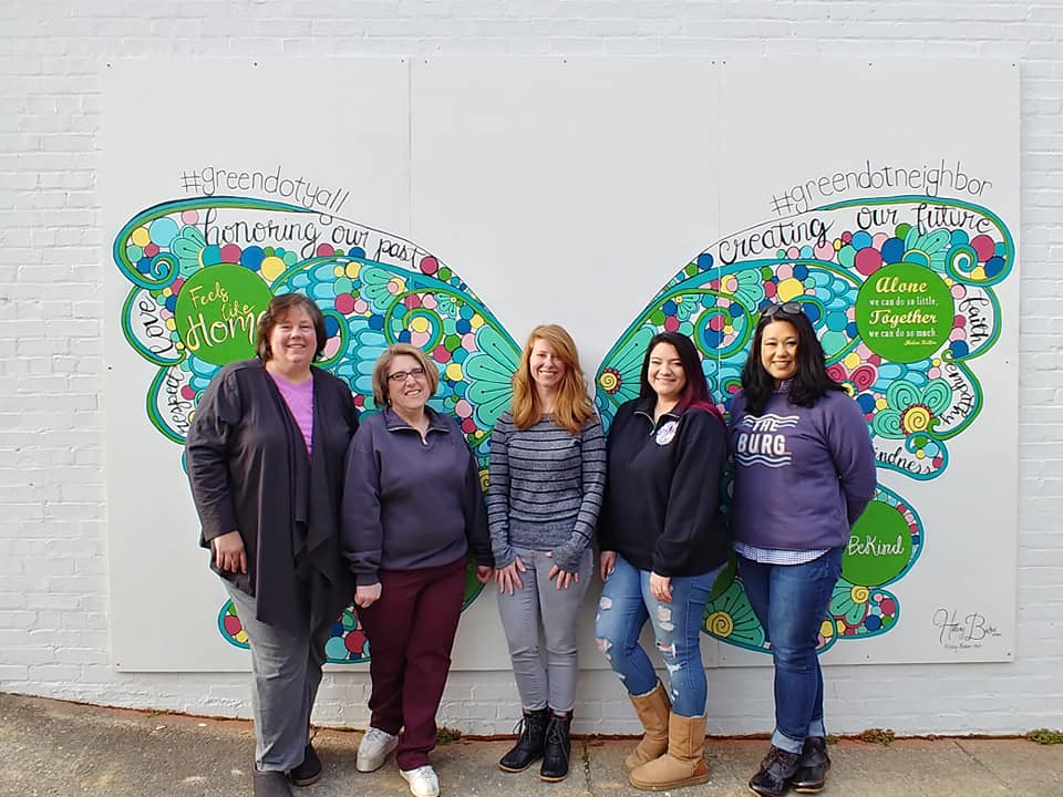 Cumberland River Green Dot volunteers stand in front of the mural in downtown Williamsburg, Kentucky. Focused on violence prevention