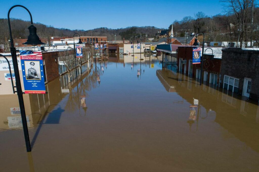 Image looking down on a flooded street in Beattyville Kentucky. Buildings are covered with water.