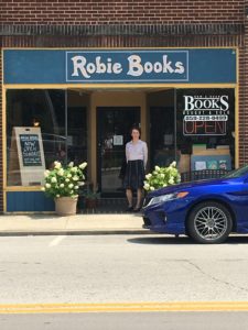 Avena Cash, owner of Robie Books, stands in front of the book store in berea, kentucky