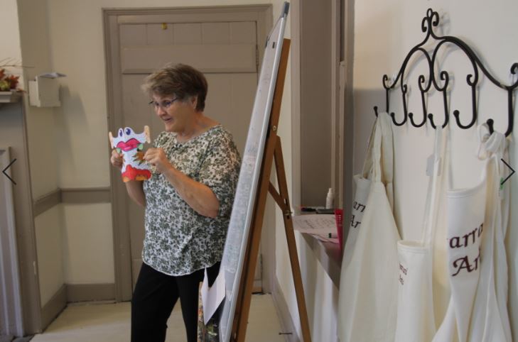 An instructor at Garrard County Arts Council leads a class of homeschooled children in art. They are a Lancaster Kentucky nonprofit 