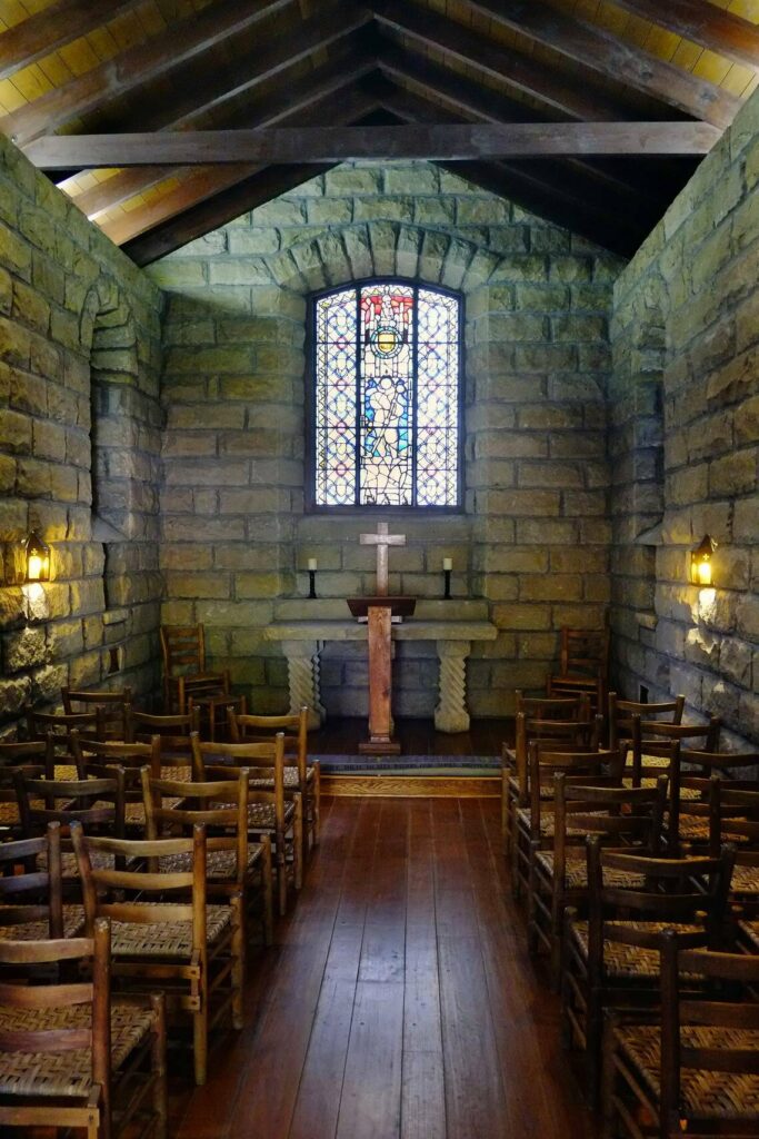 A photo of the chapel with beautiful stained glass pictured