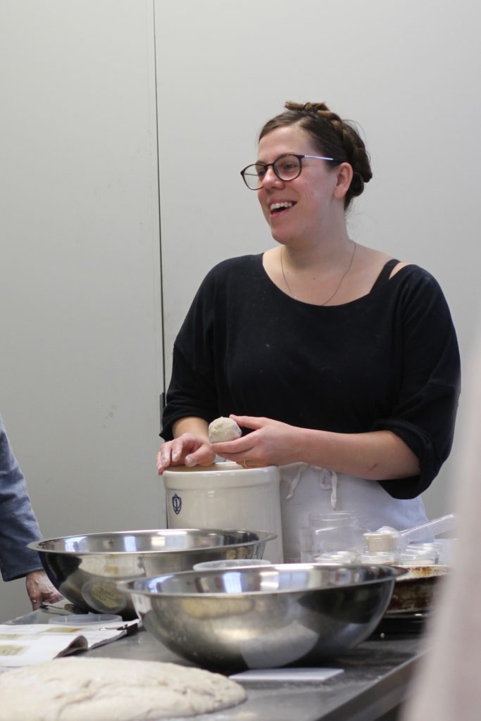 Tara Jansen smiles while teaching a baking class in eastern kentucky. She ownes SMoke signals, a mobile baking school, based in appalachia