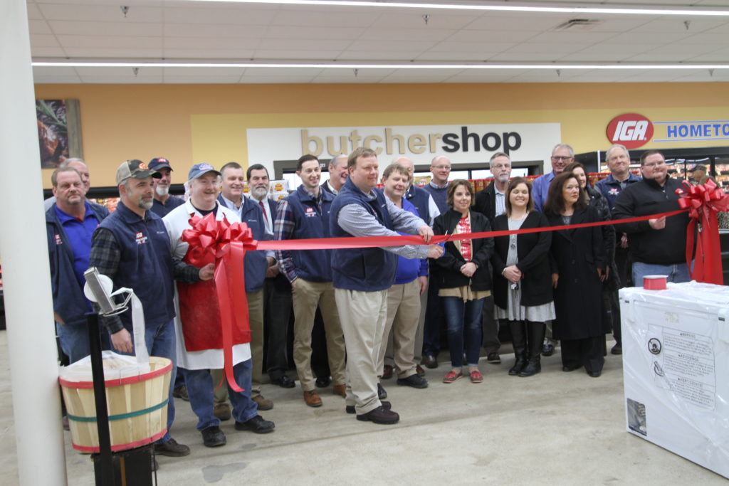 A group of salyersville iga employees cut a ribbon at a new store in magoffin county, kentucky. the new store is in a food desert
