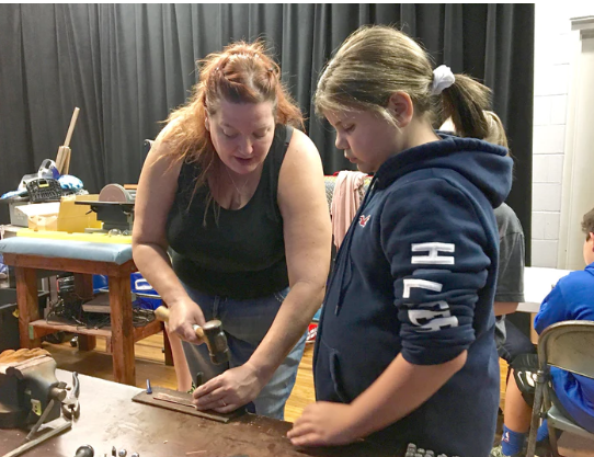 Jill Robertson standing with a student during one of her workshops