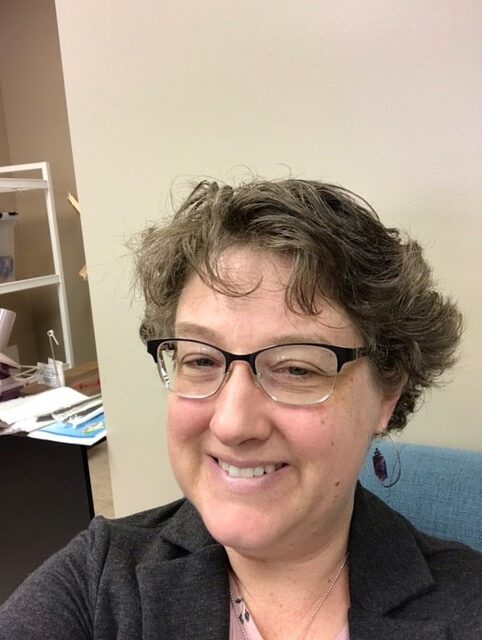 Sarah Stahl of Pink Pig Yarn Shop  smiles inside her store in Pikeville, Kentucky.