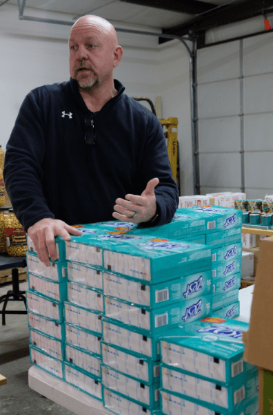 Shannon Melton, one owner of Sixth Cents Solutions, stands in their London, KY, warehouse. MACED supports with a business loan