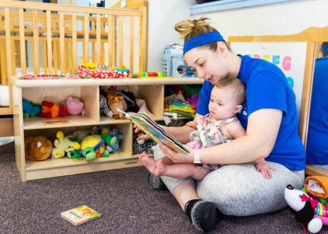 A New Beginnings staff member reading to a little one. MACED supports the childcare facility and the network with funding