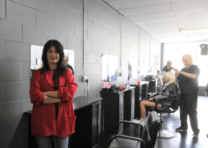 Woman business owner stands inside her beauty school in eastern kentucky. Jeanetta Thornbury is a native of johnson county, kentucky.