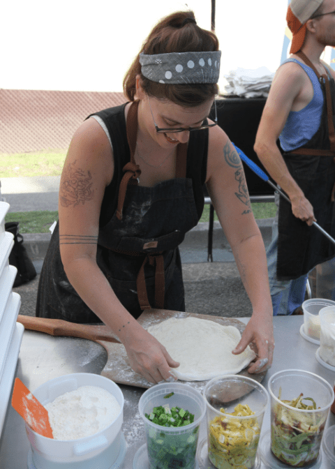 Tara Jansen from Smoke Signal Bakery makes a pizza at the Letcher County Farmers Market in Whitesburg, Kentucky.