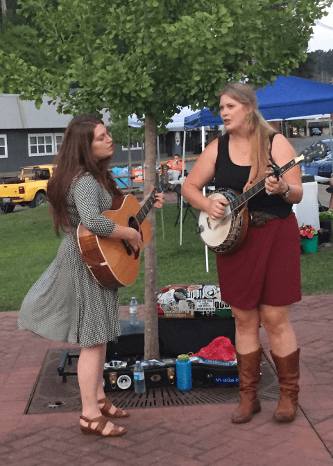 The women of the band The Local Honeys performing at Thursdays on the Triangle in perry county, kentucky. One plays banjo