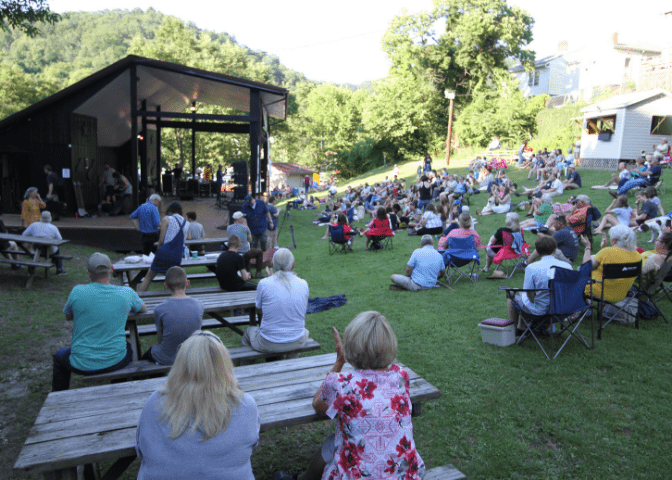 People sit on hill in letcher county, kentucky, enjoying a summer music festival. Levitt AMP foundation funds whitesburg