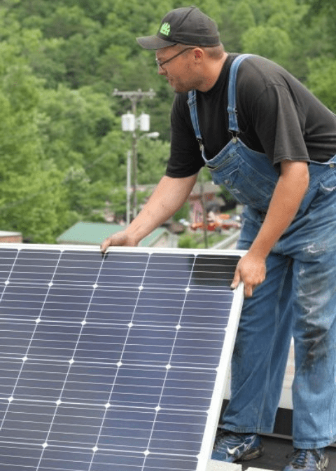 An eastern kentucky employee installs solar on the roof of a building in letcher county. Solar helps create jobs in appalachia