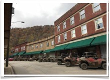 ATVs parked outside of Matewan appalachian lost and found. Part of building west virginia tourism