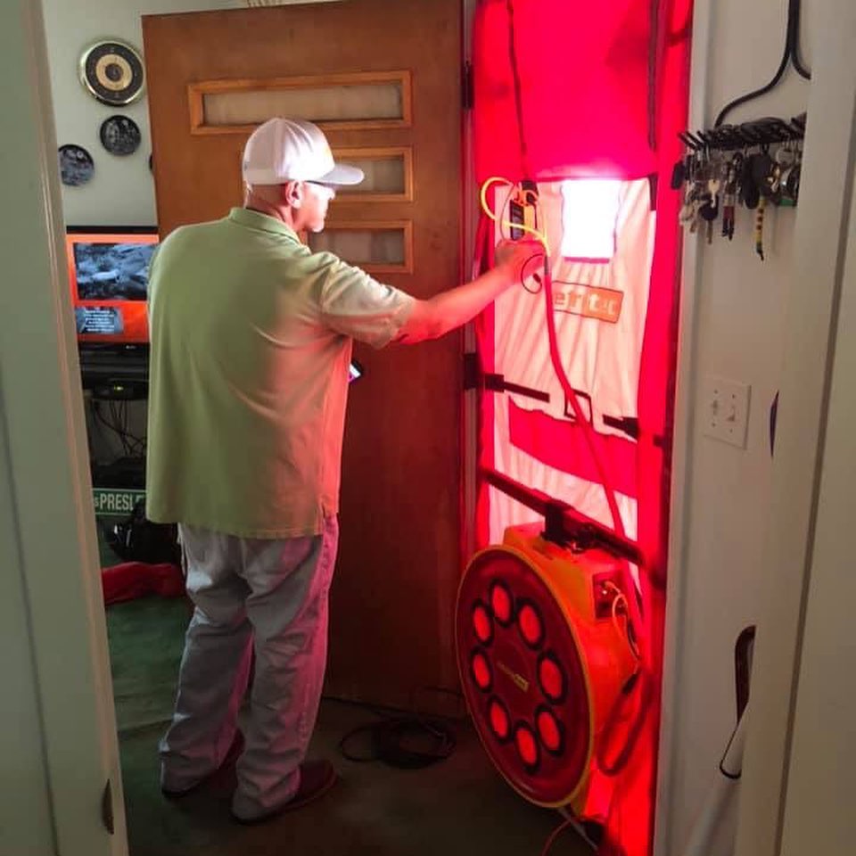 Scott conducts a blower door test to look for energy leakage in a home in Eastern Kentucky. This will help the home be more energy efficient