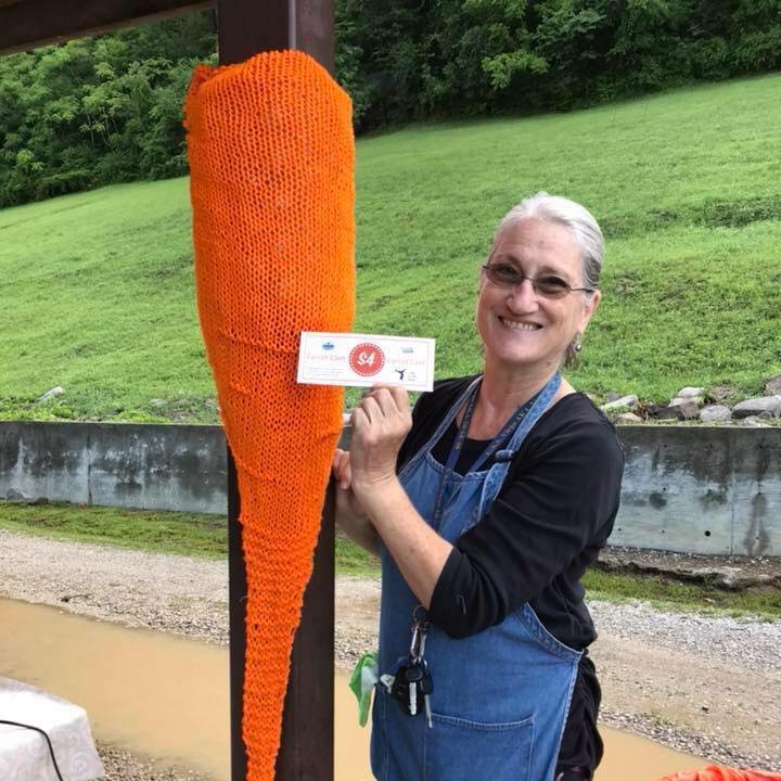 Woman stands with stuffed carrot at the Perry County Farmers Market. The Northfork Local foods manages the eastern kentucky market.