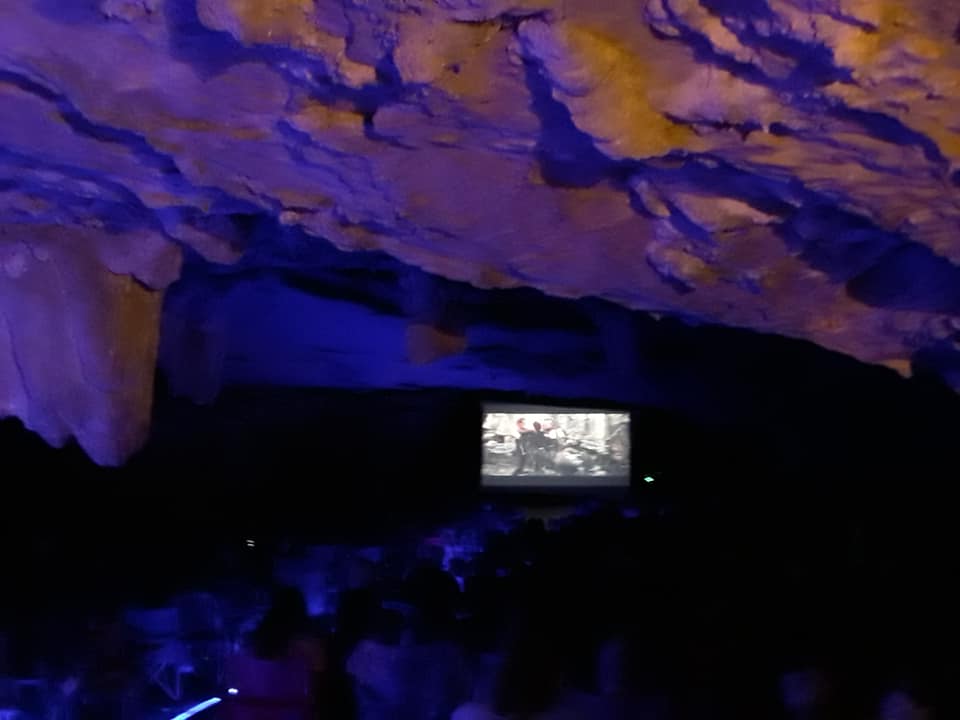 A movie screen in a dark cave at Carter Caves State Resort Park in Carter County Kentucky. The cave-in movie nights are innovative