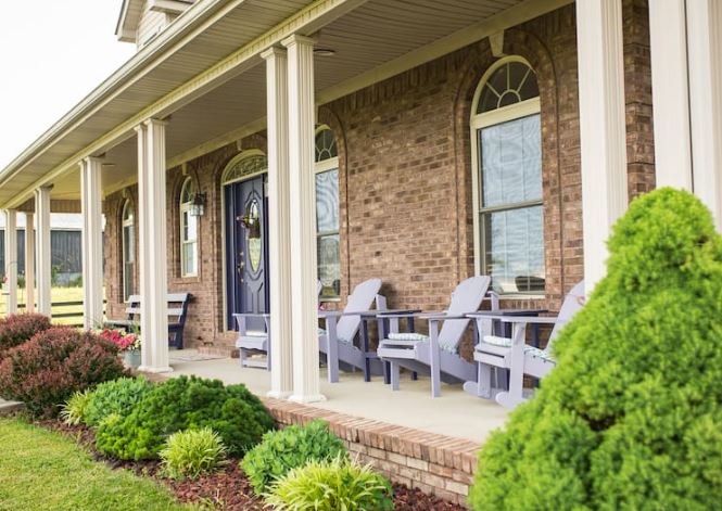 Three chairs sit on the covered porch at Clover Bottom Bed and Breakfast and airbnb in Jackson County, Kentucky.