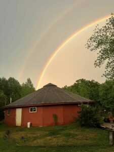 A rainbow over top of the doom roof of the refuge ridge educational center