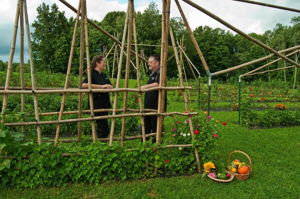 Students at Fruits of Labor stand in the garden in West Virginia. The programs include culinary arts and agriculture for at risk youth and women in recovery. 