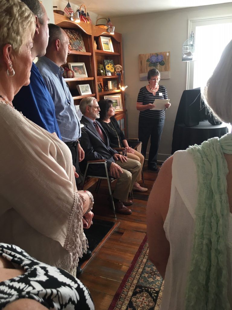 A group of community members stands inside the Garrard County Arts Council at its grant opening in 2019 in downtown lancaster, ky.
