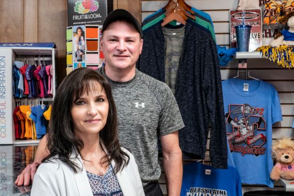 Gina Rose and Geoff Crisp of The Shirt Gallery stand inside their business in Martin, Kentucky, in Floyd County.