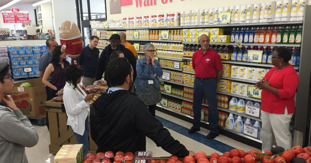 Gwen Christon with a group of people touring her store, Isom IGA, in Letcher County, Kentucky. The store leads in rural energy savings