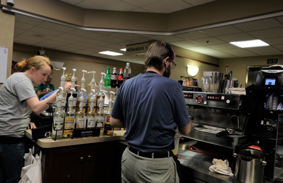 Two employees work behind the coffee counter at Pour House Coffee in King's Daughter Medical Center and Hospital in Ashland, KEntucky.