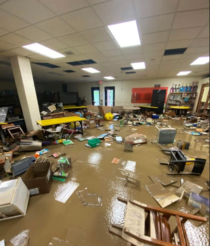 The library at West Whitesburg Elementary with standing water and floating books and furniture.