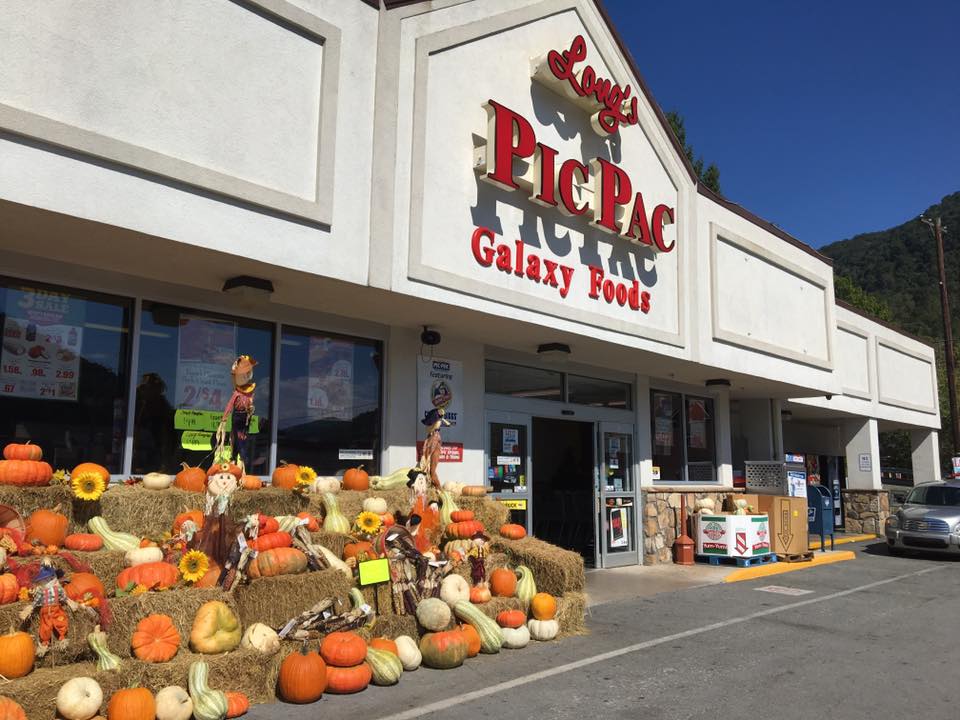 Pumpkins sit on hay bales outside in front of the grocery store sign for Long's Pic Pac in Bell county, kentucky.