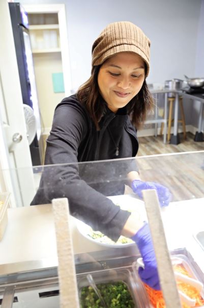 Mae Suramek serves noodles at Noodle Nirvana her business in Berea Kentucky. The woman owned restaurant is a social enterprise