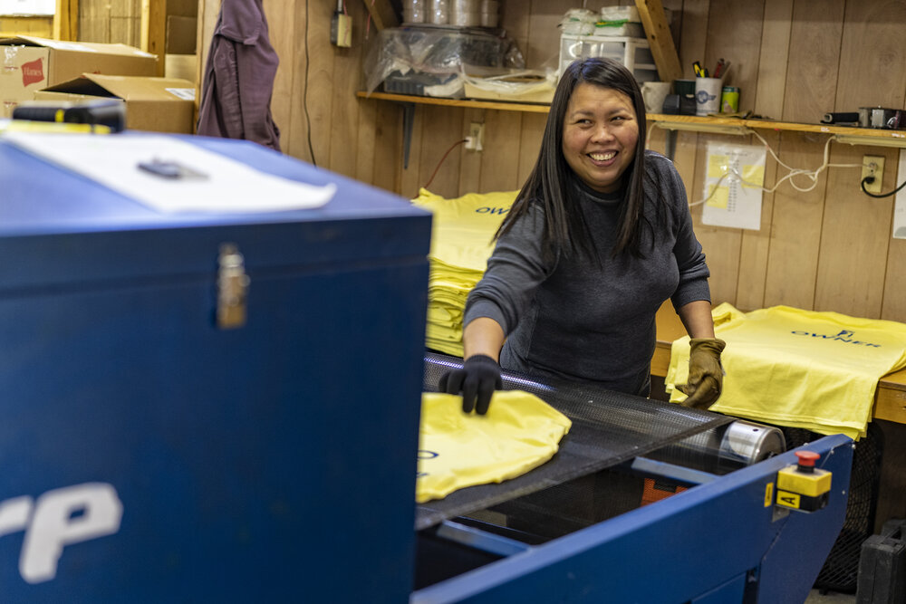 An employee screen prints a shirt at the shirt gallery in martin, kentucky.