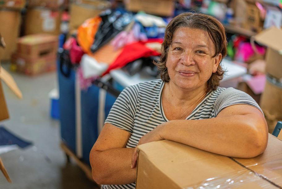 An employee at the Methodist Mountain Mission warehouse in Jackson, KY. Photo by Malcolm Wilson, appalachian artist. 