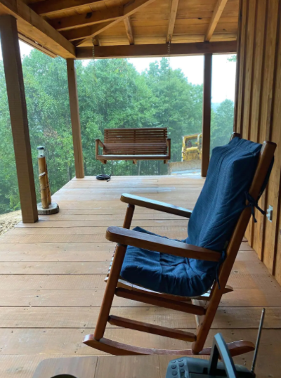 A rocking chair on a porch at an airbnb in clay county, kentucky.