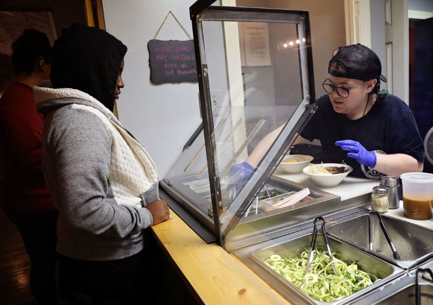 Employee serves noodles at Noodle Nirvana, a Berea, Kentucky, social enterprise restaurant. Hole and Corner uses the same space